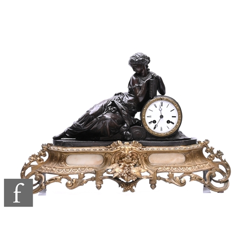 743 - A 19th Century French bronzed spelter mantle clock modelled as a Romanesque female reclining and res... 