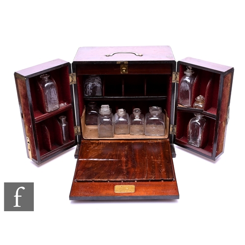 566 - A 19th Century mahogany apothecary's cabinet, fitted with various clear blown glass bottles enclosed... 