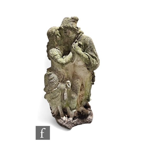 932 - A 20th Century composite stone figure of two lovers clasping hands, height 74cm.