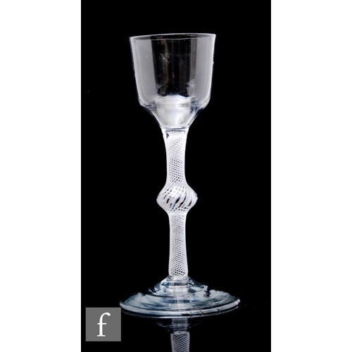 246 - A large 18th Century wine glass circa 1765, the ogee bowl above a tall single series opaque twist st... 