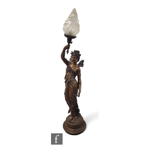 584 - A large 19th Century spelter figure of a classical winged Romanesque female holding a torch and stan... 