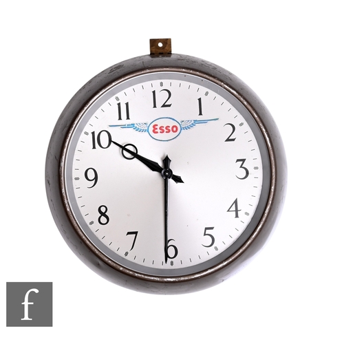 753 - A 1950s or earlier circular wall clock, key wind operation labelled Esso, diameter 25cm.