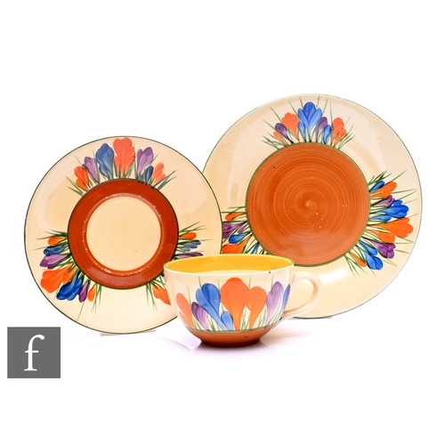 178 - A Clarice Clif Globe shape tea cup, saucer and side plate circa 1931, hand painted with Crocus spray... 