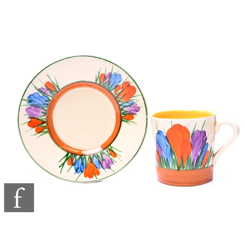 179 - A Clarice Cliff Tankard shape coffee can and saucer circa 1930, hand painted with Crocus sprays with... 