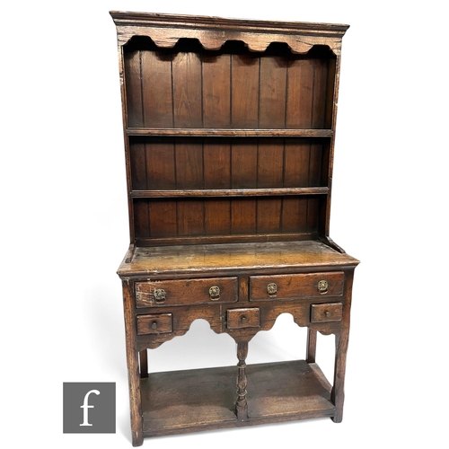 844 - A small 17th Century style oak dresser and rack fitted with three short drawers over three small dra... 