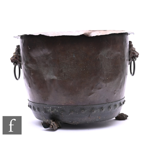 603 - An early 20th Century circular copper coal bin, lion mask ring handles on paw feet, diameter 53cm.