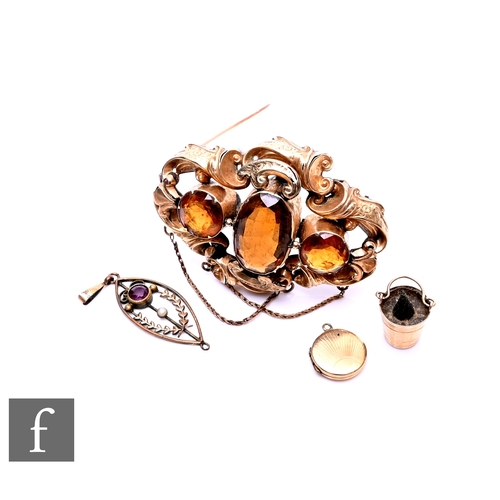 409 - A Victorian/Edwardian gilt metal and citrine set brooch, the scrolling acanthus design with three in... 