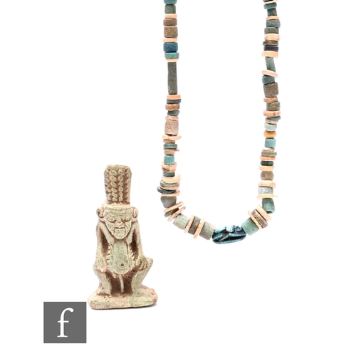 615 - An ancient Egyptian coloured bead necklace with scarab mount, a cylinder section from a sarcophagus ... 