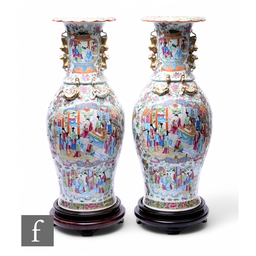 378 - A pair of Chinese late Qing Dynasty Canton famille rose vases, each of baluster form, rising to a fl... 