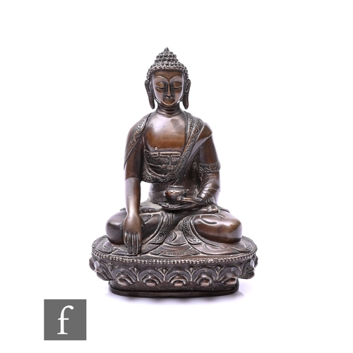 379 - A 19th/20th Century Sino-Tibetan figure of a seated Buddha, seated in lotus position, hands cast in ... 