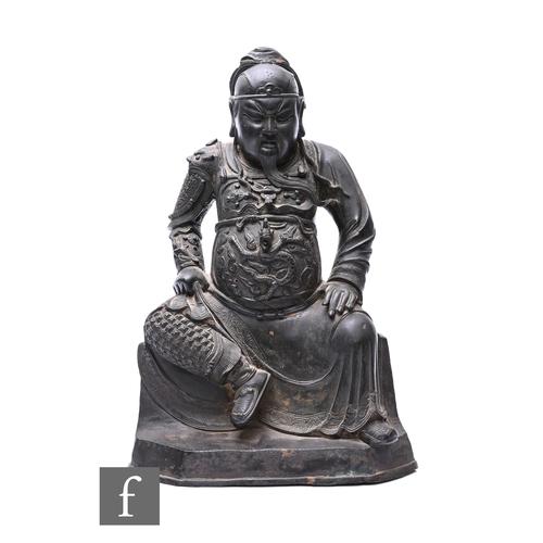 380 - A 19th Century Chinese/Tibetan patinated bronze figure of Daoist deity Zhenwu, cast in seated positi... 