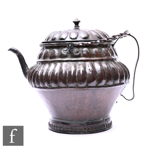 389 - A 19th Century Middle Eastern hammered patinated brass teapot, of large size with short spout and ea... 