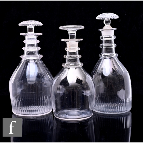 301 - A late Georgian taper form decanter with fine basal cutting below a slice cut neck with three rings,... 