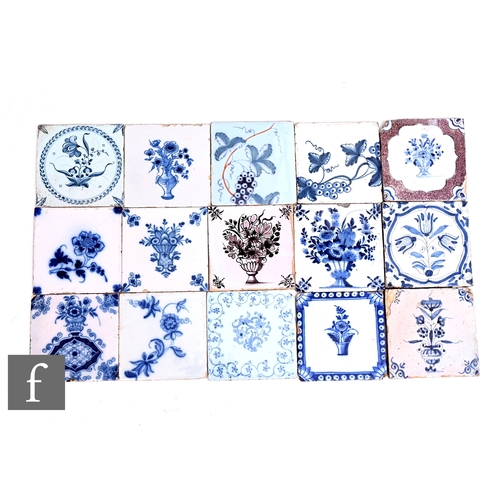 128 - A collection of 18th Century English Delft 5 inch tiles, each decorated with floral studies in blue ... 