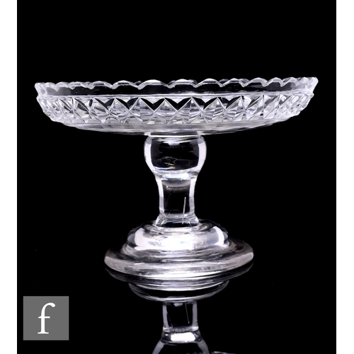 308 - An early 19th Century miniature clear crystal glass pedestal taza, the shallow dish form top with sc... 