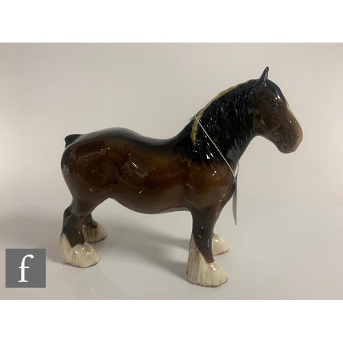 65 - A Beswick pottery figure of a shire horse, with plaited mane, height 21cm, together with a Beswick c... 