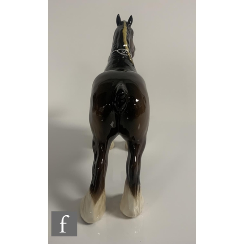 65 - A Beswick pottery figure of a shire horse, with plaited mane, height 21cm, together with a Beswick c... 