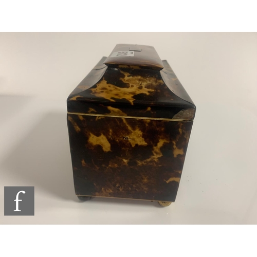 512 - A 19th Century tortoiseshell tea caddy, the caddy shaped top over a two divisioned interior, on bras... 