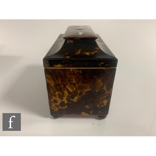 512 - A 19th Century tortoiseshell tea caddy, the caddy shaped top over a two divisioned interior, on bras... 