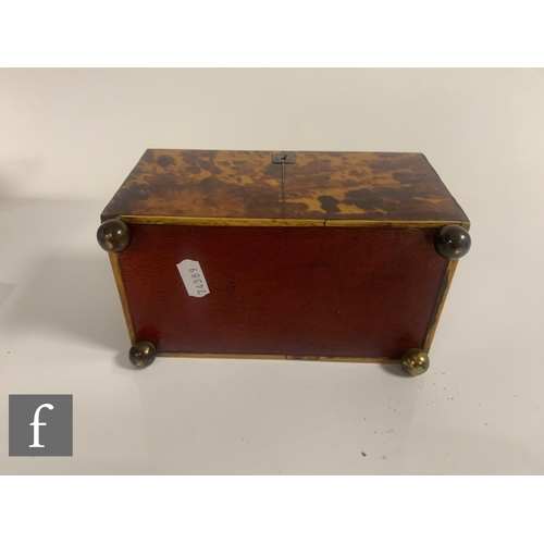 512 - A 19th Century tortoiseshell tea caddy, the caddy shaped top over a two divisioned interior, on bras... 