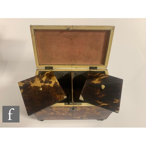 512 - A 19th Century tortoiseshell tea caddy, the caddy shaped top over a two divisioned interior, on bras... 