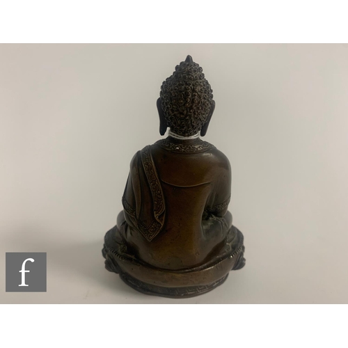 379 - A 19th/20th Century Sino-Tibetan figure of a seated Buddha, seated in lotus position, hands cast in ... 