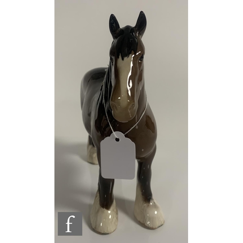 65 - A Beswick pottery figure of a shire horse, with plaited mane, height 21cm, together with a Beswick c... 