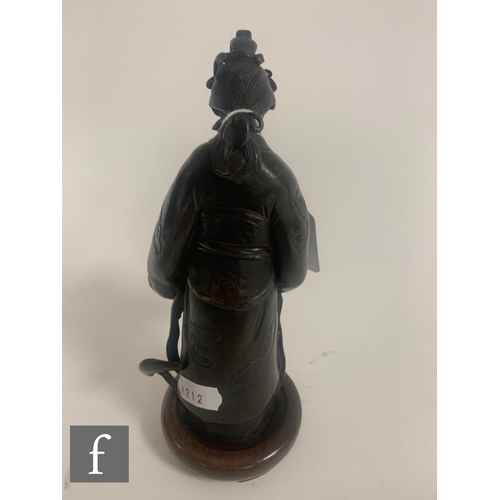 387 - A Japanese late Meiji Period (1868-1912) figure of Shou Lao, modelled dressed in robes and holding a... 