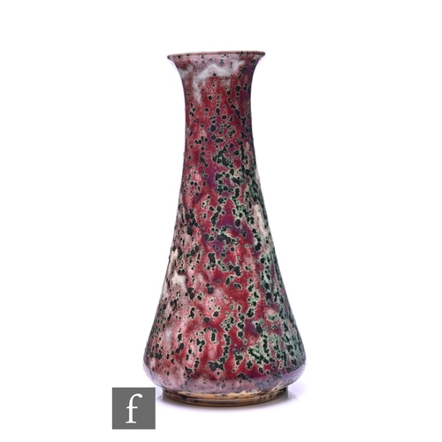 186 - Ruskin - An early 20th Century high fired vase of conical form, sang de beouf glaze with heavy coppe... 