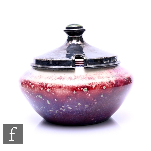 195 - Ruskin Pottery - A High Fired jar, of compressed ovoid form, purple over sang de boeuf glaze, the as... 