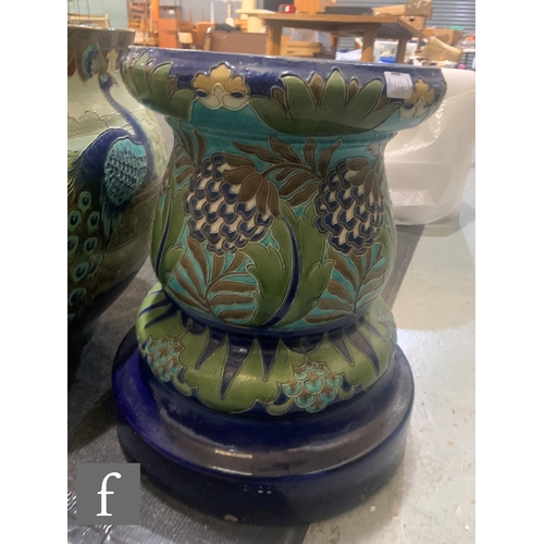 14 - Burmantofts - An Art Nouveau jardiniere and stand, the large swollen ovoid bowl relief decorated wit... 