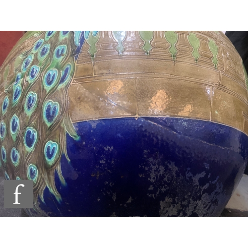 14 - Burmantofts - An Art Nouveau jardiniere and stand, the large swollen ovoid bowl relief decorated wit... 