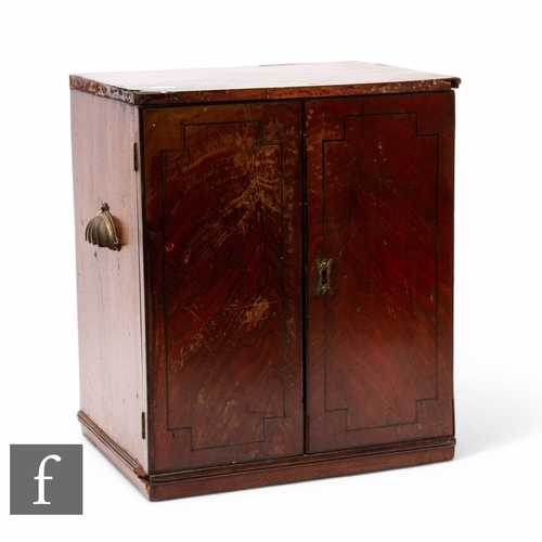 52 - A Edwardian mahogany table top coin cabinet fitted with eleven sliding divisional trays enclosed by ... 