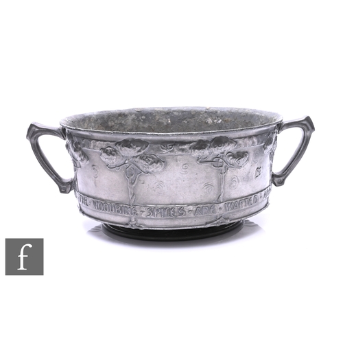 81 - David Veasey - Liberty & Co - A Tudric pewter twin handled rose bowl, relief moulded rose bushes... 