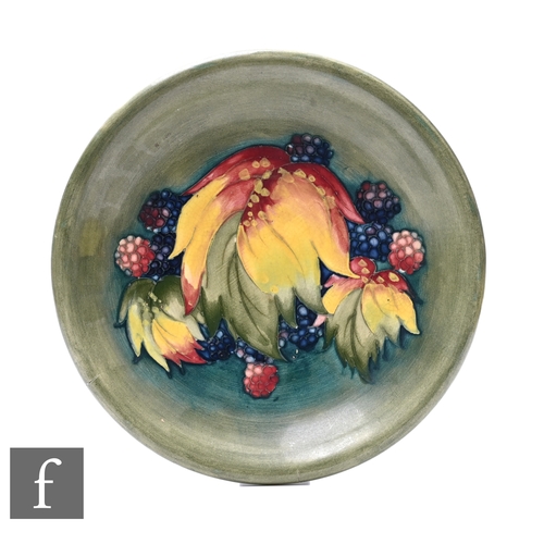 235 - William Moorcroft - Moorcroft Pottery - A plate of shallow circular section, circa 1930 tube line de... 