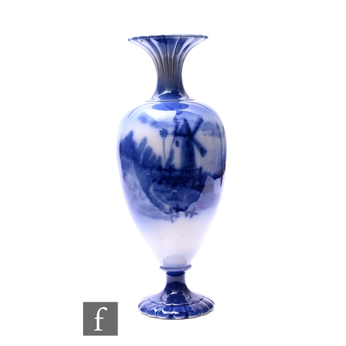 316 - Wiltshaw & Robinson - Carlton Ware - A flow blue footed vase, circa 1900, of ovoid form with flu... 