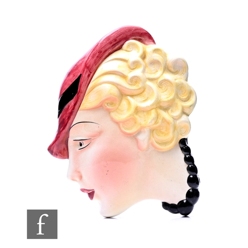 731 - J H Cope & Co - An Art Deco wall mask, circa 1930, side portrait of a lady with blonde curls und... 