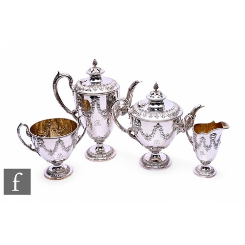 A Victorian hallmarked silver four piece pedestal tea service, decorated with embossed and engraved foliate swags below beaded borders, weight 90ozt, each terminating in acanthus capped handles. London 1884, Martin, Hall & Co.