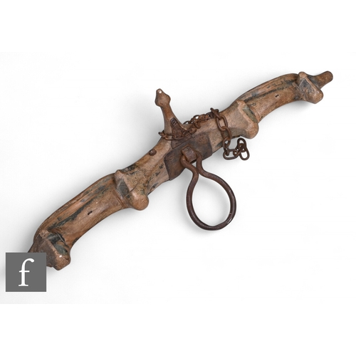A carved wooden Oxen yoke, shaped frame, iron fittings, chain and ring ...
