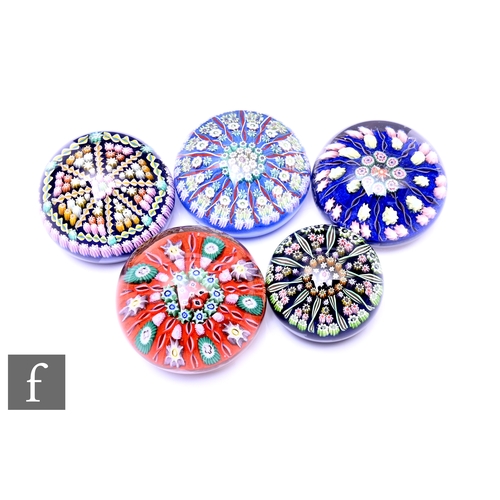 A group of 20th Century Scottish glass paperweights, including Perthshire cartwheel type paperweight millefiori and spiral canes with border of millefiori canes, signature cane within design, with two other Perthshire millefiori cane cartwheel paperweights, and two Vasart millefiori cartwheel design paperweights, largest diameter 8cm. (5)