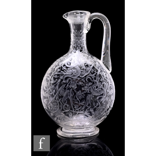 A late 19th Century Stourbridge clear crystal glass claret jug circa 1870, attributed to James O'Fallon for Thomas Webb, the footed compressed ovoid body rising to a slender collar neck with integral spout and high arched handle, the body profusely engraved with dragons and beasts amongst heavy foliate scrolls with further animals hidden amongst the pattern including a bat, squirrel, lizard and a cat chasing a mouse, the handle further finely engraved with a repeat designs, unsigned, height 27cm.