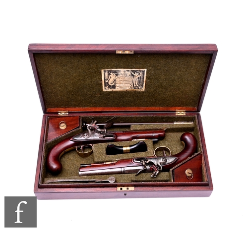 A 19th Century cased pair of flintlock pistols by H W Mortimer London, 17cm barrels, each with ram rods, brass trigger guard and furniture, plain butts, in fitted plush lined case, the lid labelled 'H.W Mortimer gun maker', width 40cm.