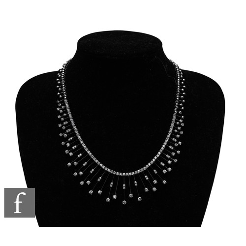 1046 - A diamond fringe necklace, the front section set with a uniform row of brilliant-cut diamonds, suspe... 