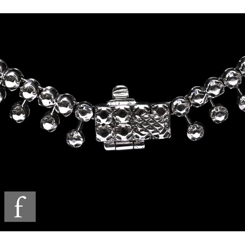 1046 - A diamond fringe necklace, the front section set with a uniform row of brilliant-cut diamonds, suspe... 