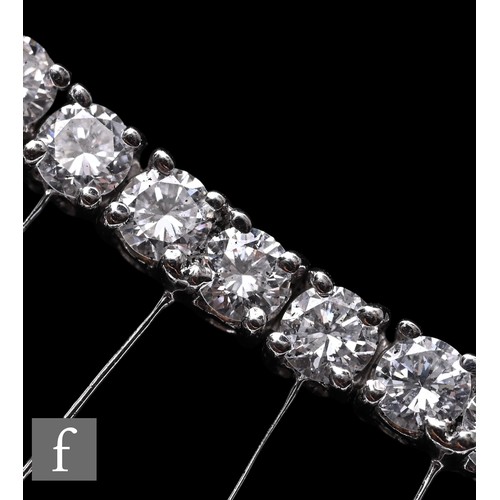 1046 - A diamond fringe necklace, the front section set with a uniform row of brilliant-cut diamonds, suspe... 