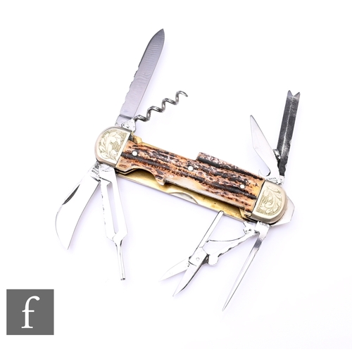 A Stan Shaw eight blade pocket knife, with work back blades and integral flat head screwdriver, stag horn scales and brass linings, with engraved nickel silver bolsters, the blades and tools stamped S. Shaw Sheffield England, length when closed approximately 10.5cm.