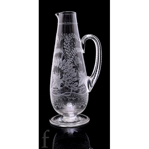518 - A late 19th Century Stourbridge clear crystal claret jug of footed tapered sleeve form with applied ... 