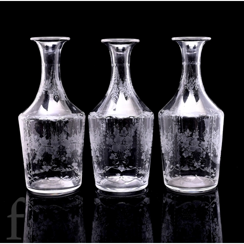 520 - A set of three late 19th Century wine carafes, each of shouldered cylindrical form with swept neck, ... 