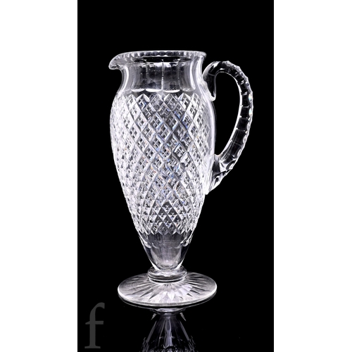 522 - A late 19th Century Stourbridge clear cut crystal water jug of slender ovoid form with applied loop ... 
