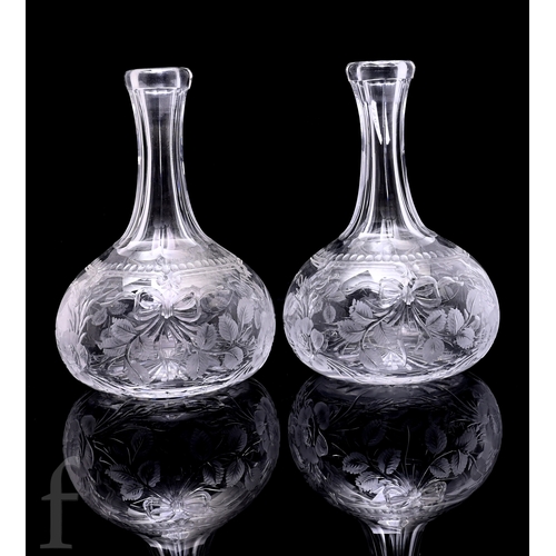 523 - A pair of 20th Century Tudor Crystal carafes of compressed globe and shaft form polish intaglio cut ... 